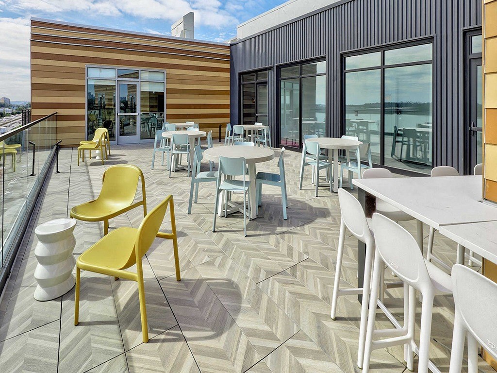 a patio with tables and chairs and windows